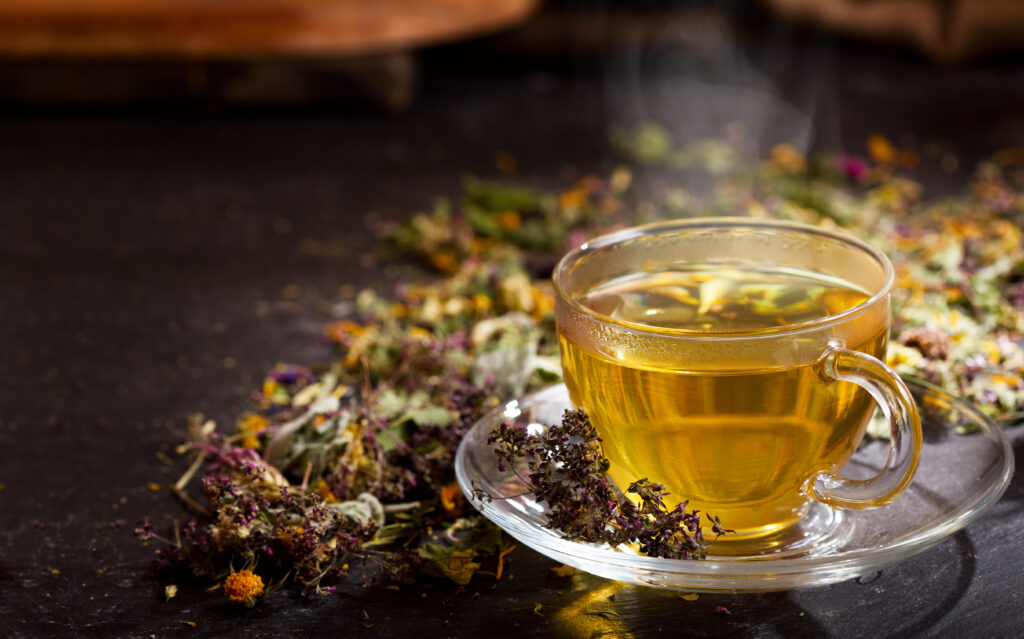 cup of herbal tea with various herbs